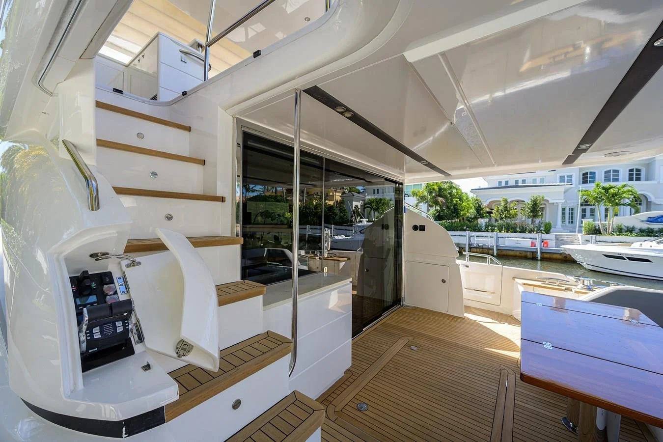 Aft deck access and flybridge staircase aboard Paulasea, a privately owned Princess 68 Flybridge yacht available for private charter in Palm Beach, Florida.