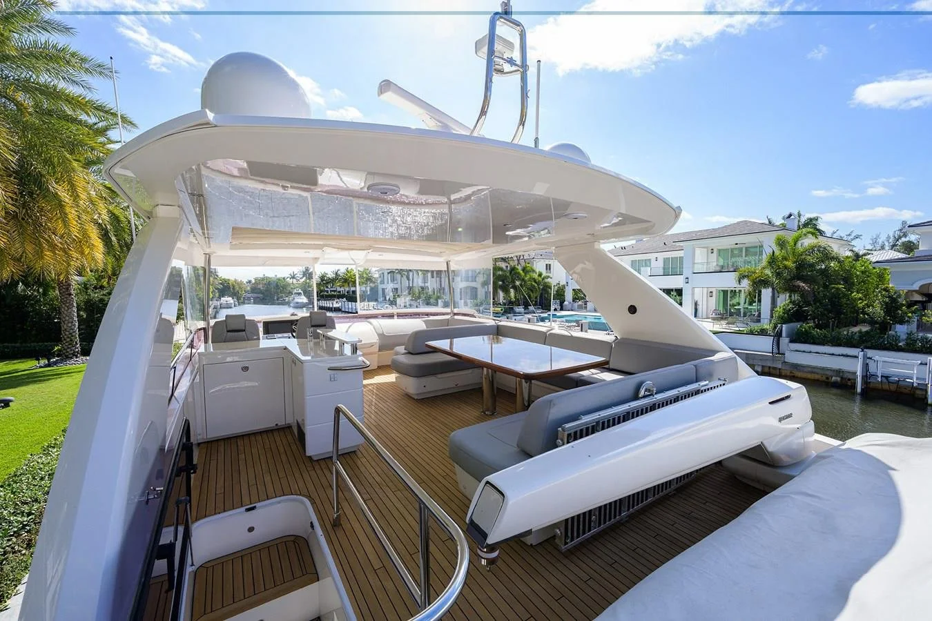 Flybridge lounge and dining area aboard Paulasea, a privately owned Princess 68 Flybridge yacht available for private charter in Palm Beach, Florida.