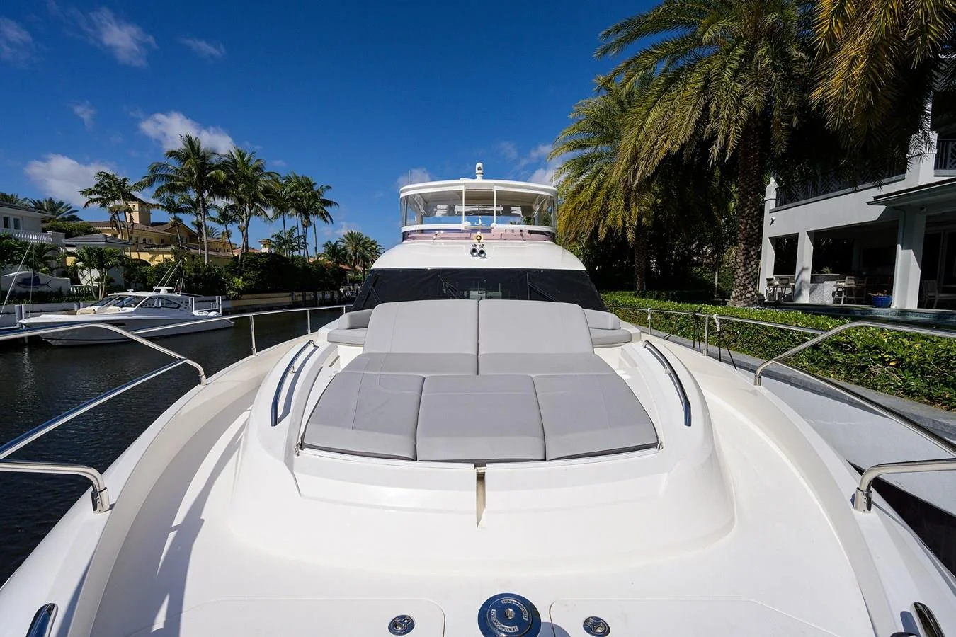 Forward bow sunpad and foredeck seating aboard Paulasea, a privately owned Princess 68 Flybridge yacht available for private charter in Palm Beach, Florida.