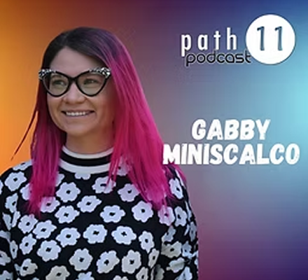 Podcast cover featuring Gabby Miniscalco with pink hair, black glasses, and a black and white floral top, with a colorful gradient background and white text indicating 'path 11 podcast'.