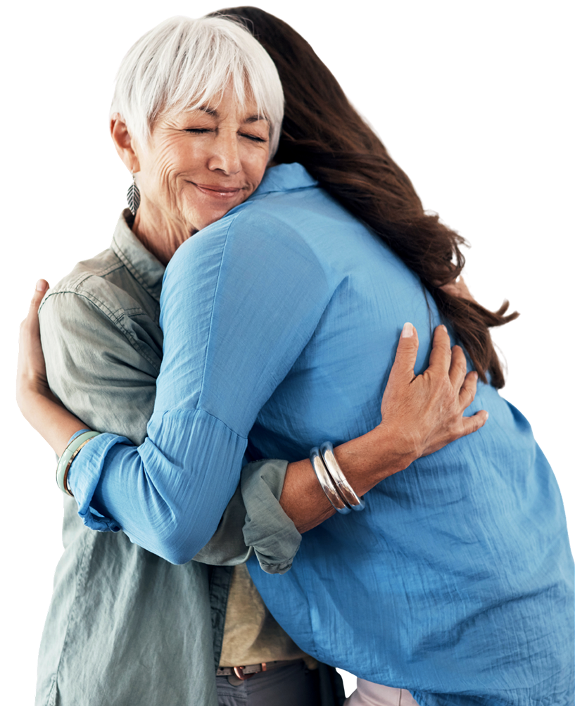 Two women hugging, one with short white hair and the other with long dark hair, smiling with their eyes closed.
