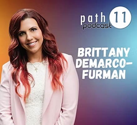 Podcast cover featuring a woman with long, wavy red hair wearing a light pink blazer and white blouse, smiling. Text includes 'Path 11 podcast' and 'Brittany DeMarco-Furman.'