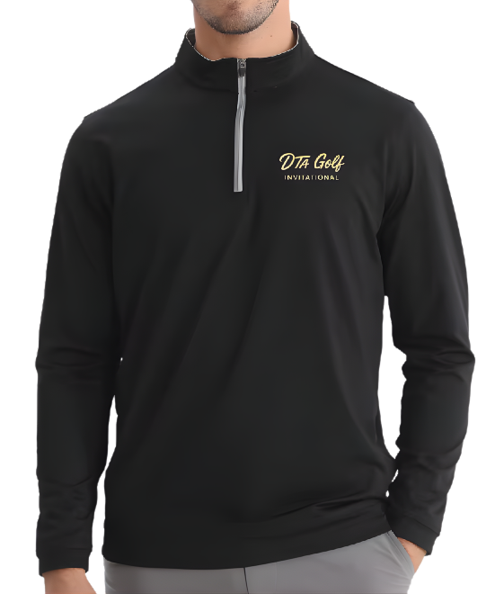 Man wearing black quarter-zip golf jacket with 'DTA Golf Invitational' logo in gold on the upper left chest, standing with hand in pocket against a pink background.