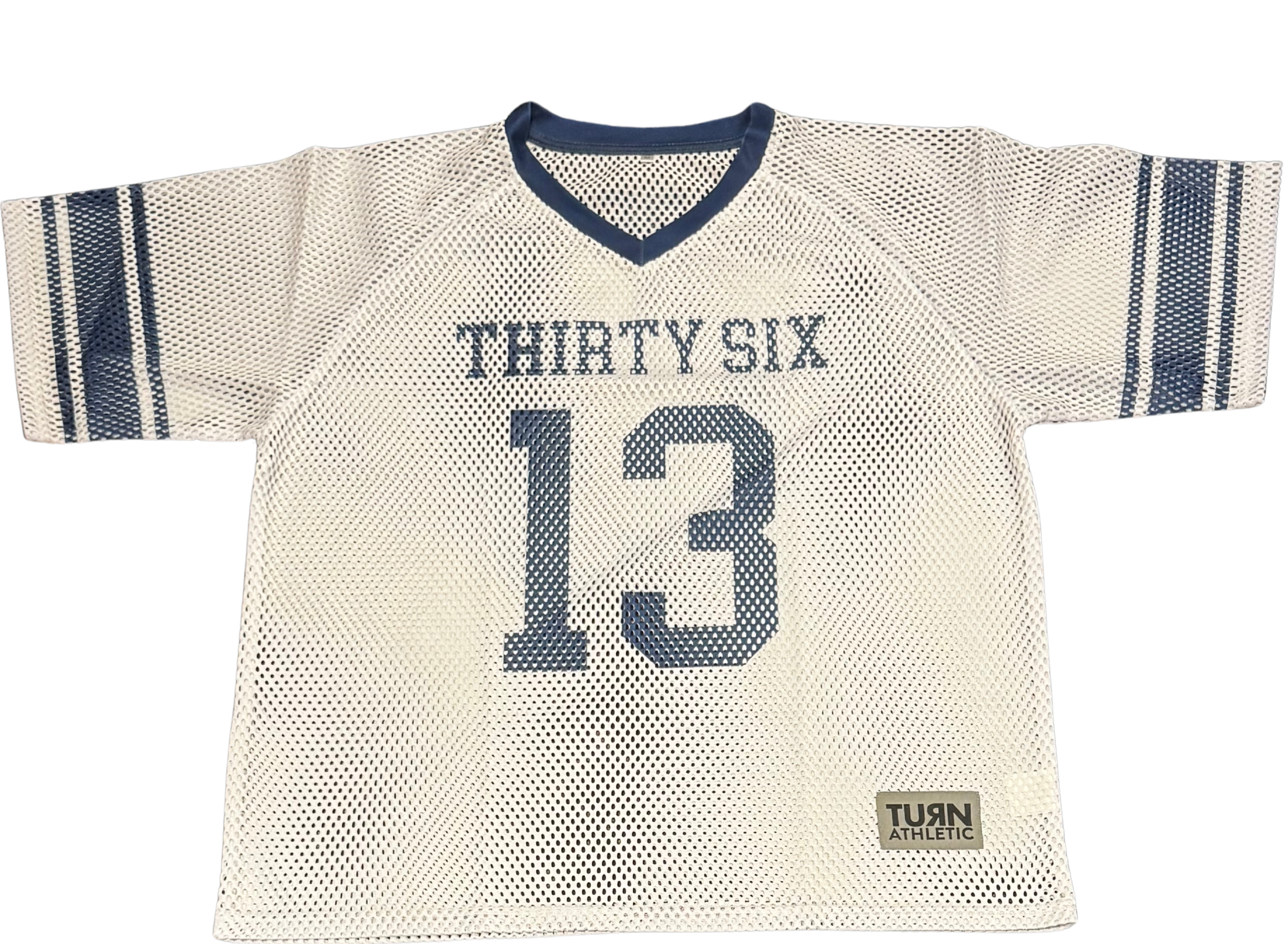 White sports jersey with blue trim, labeled 'THIRTY SIX' and number '13' on front, with blue stripes on sleeves, and a small label reading 'TURN ATHLETIC' at bottom right.