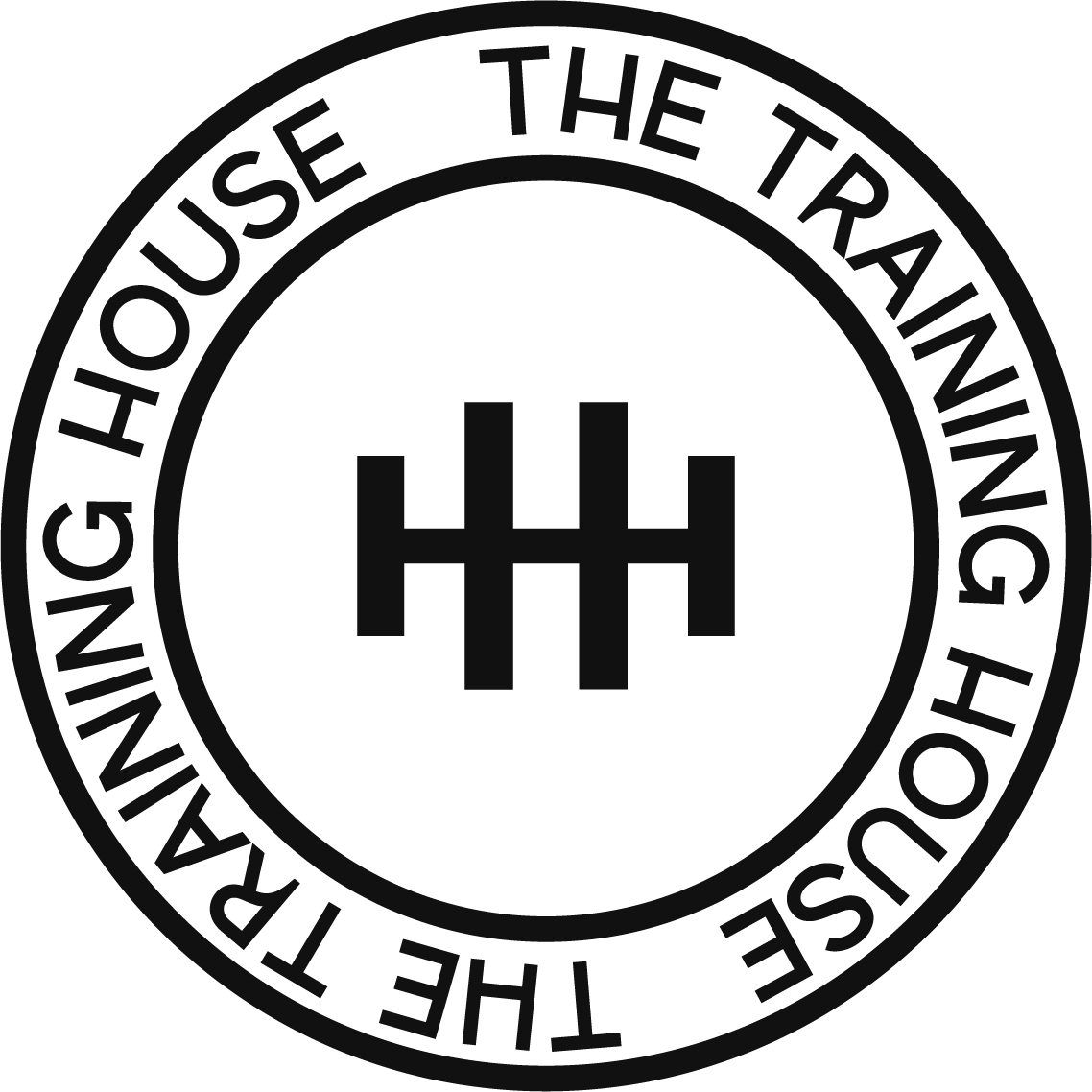 The logo of The Trailing House, a company specializing in trail running gear, featuring a stylized mountain and the company's name in a circular design.