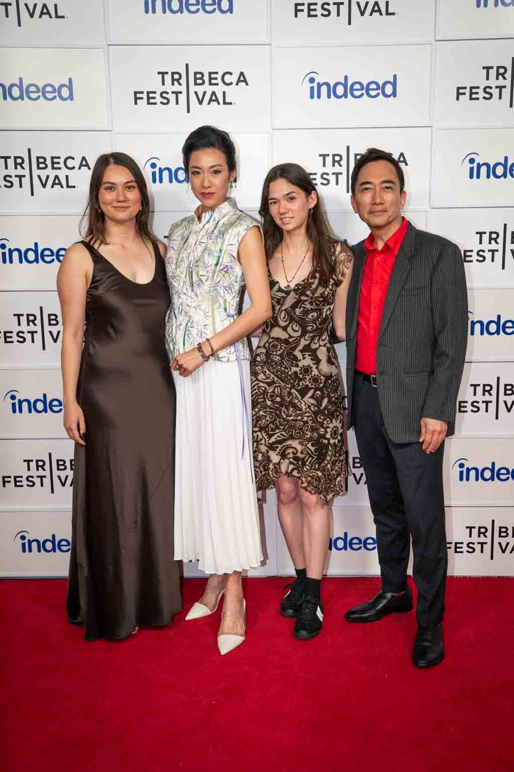 Four individuals posing on a red carpet in front of a backdrop with the logos 'TriBeCa Festival' and 'Indeed'.