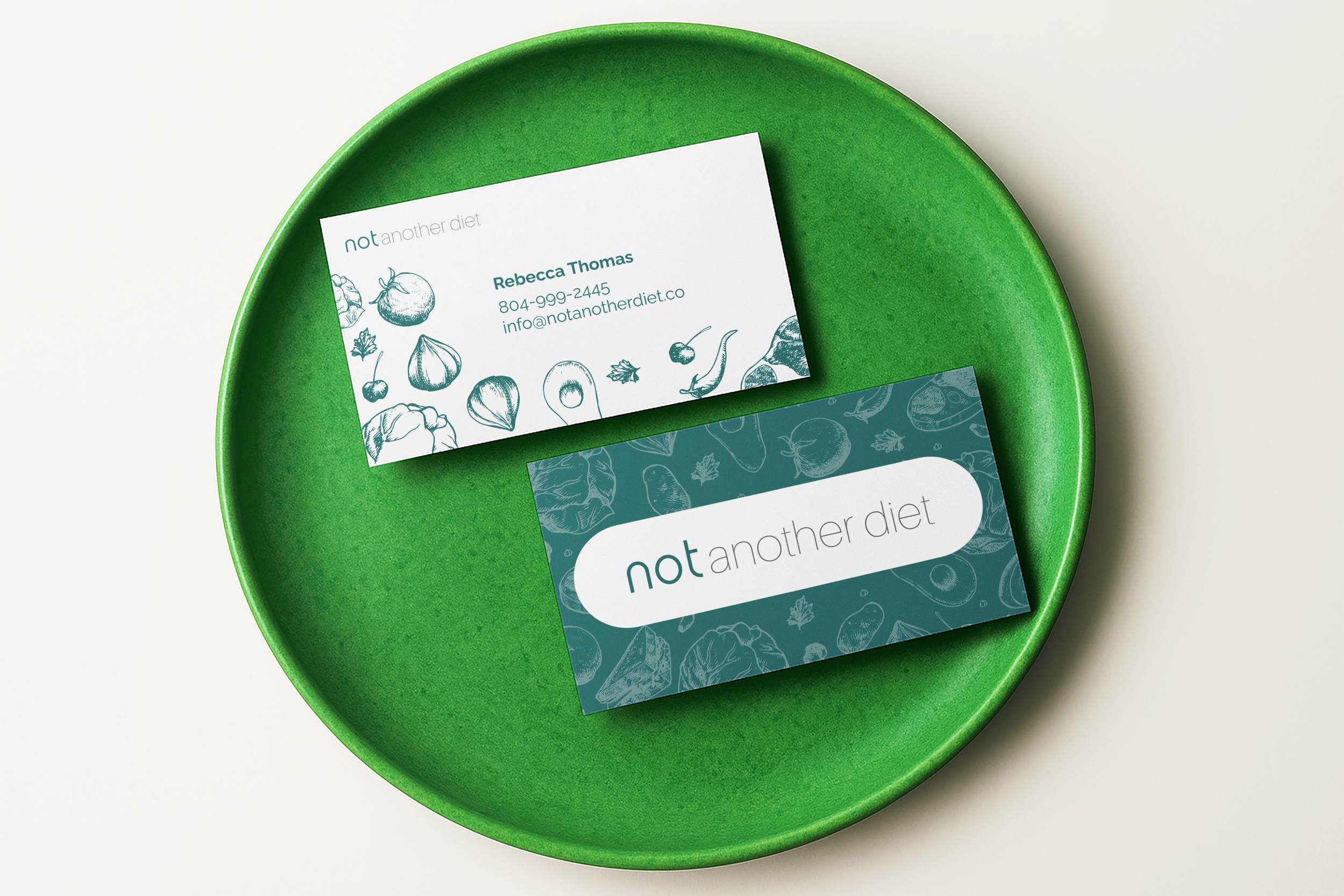 A green plate holding two cards with the phrase "not another diet" and illustrations of vegetables.