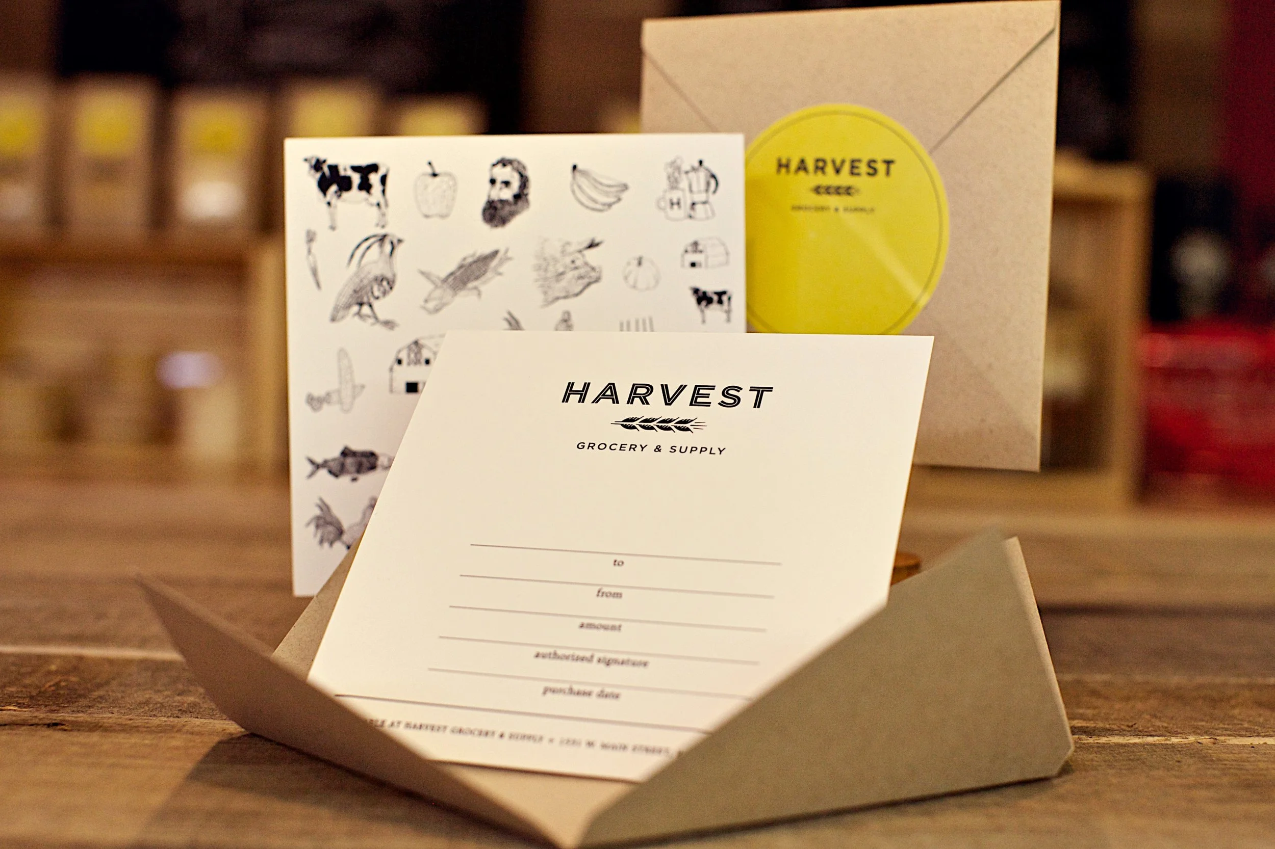 A grocery order receipt from Harvest Grocery & Supply, with illustrations of farm animals, fruits, and vegetables visible in the background.