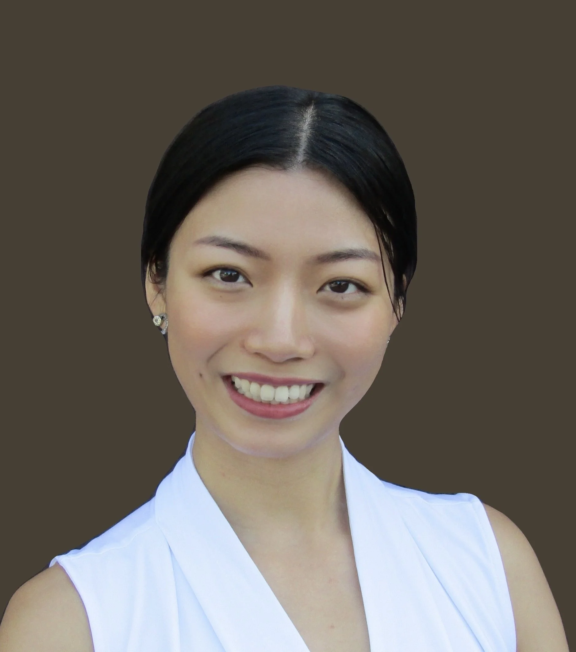 Headshot of woman with dark hair pulled back in a sleeveless white top. 