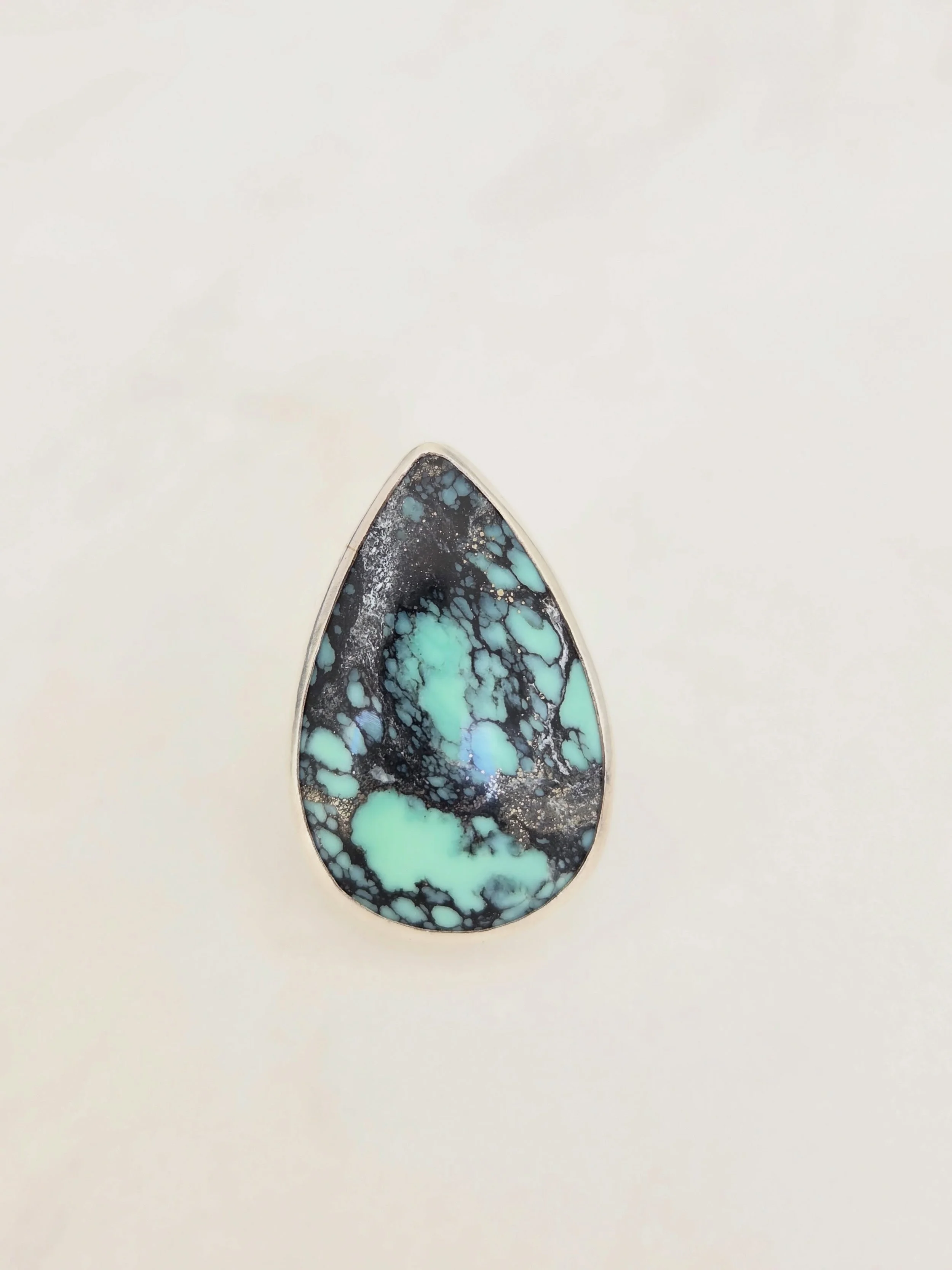 This stone is a statement. Persian Variscite Earth Mined in Iran. The mint color is so vibrant and pops gorgeously against the spidering jet black manganese. She is not to be missed. Available now on the website. Link in bio. #earthmined #statementri