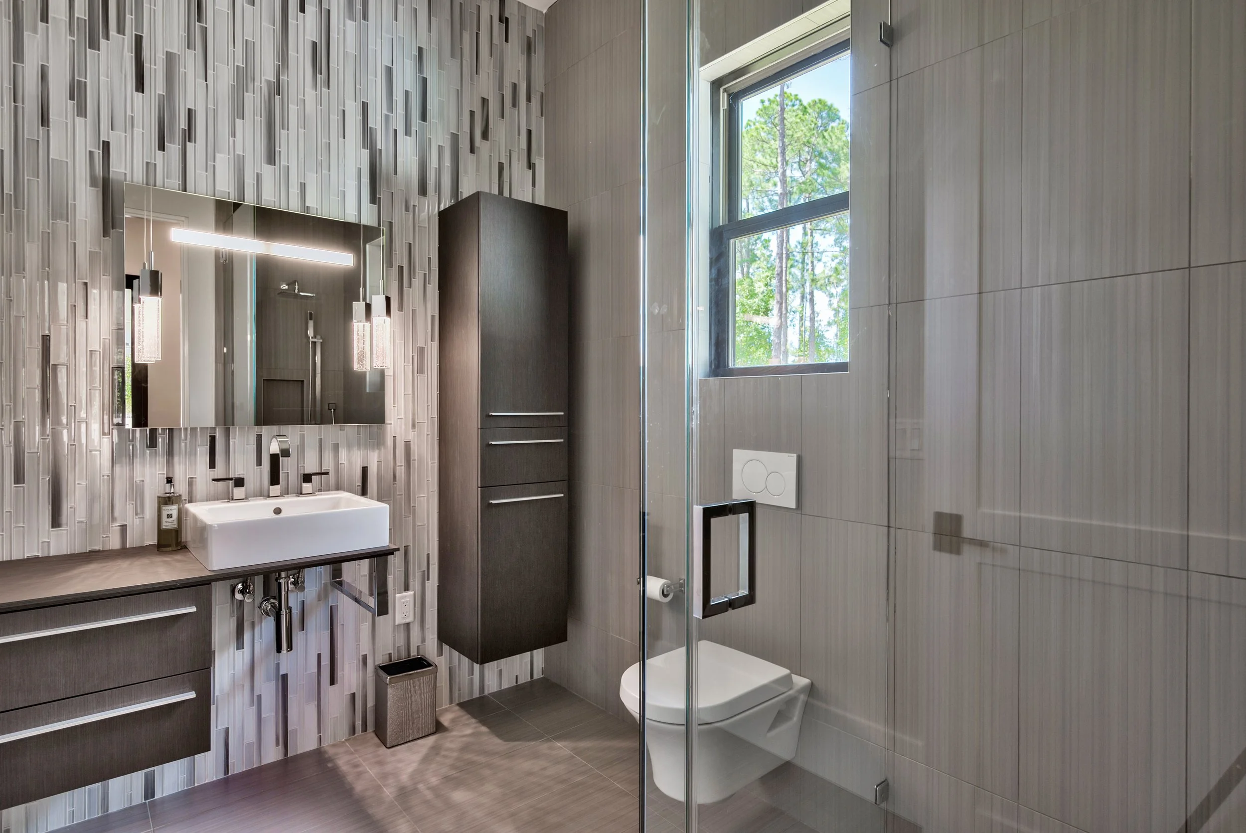 Modern bathroom remodel with textured tile and floating vanity