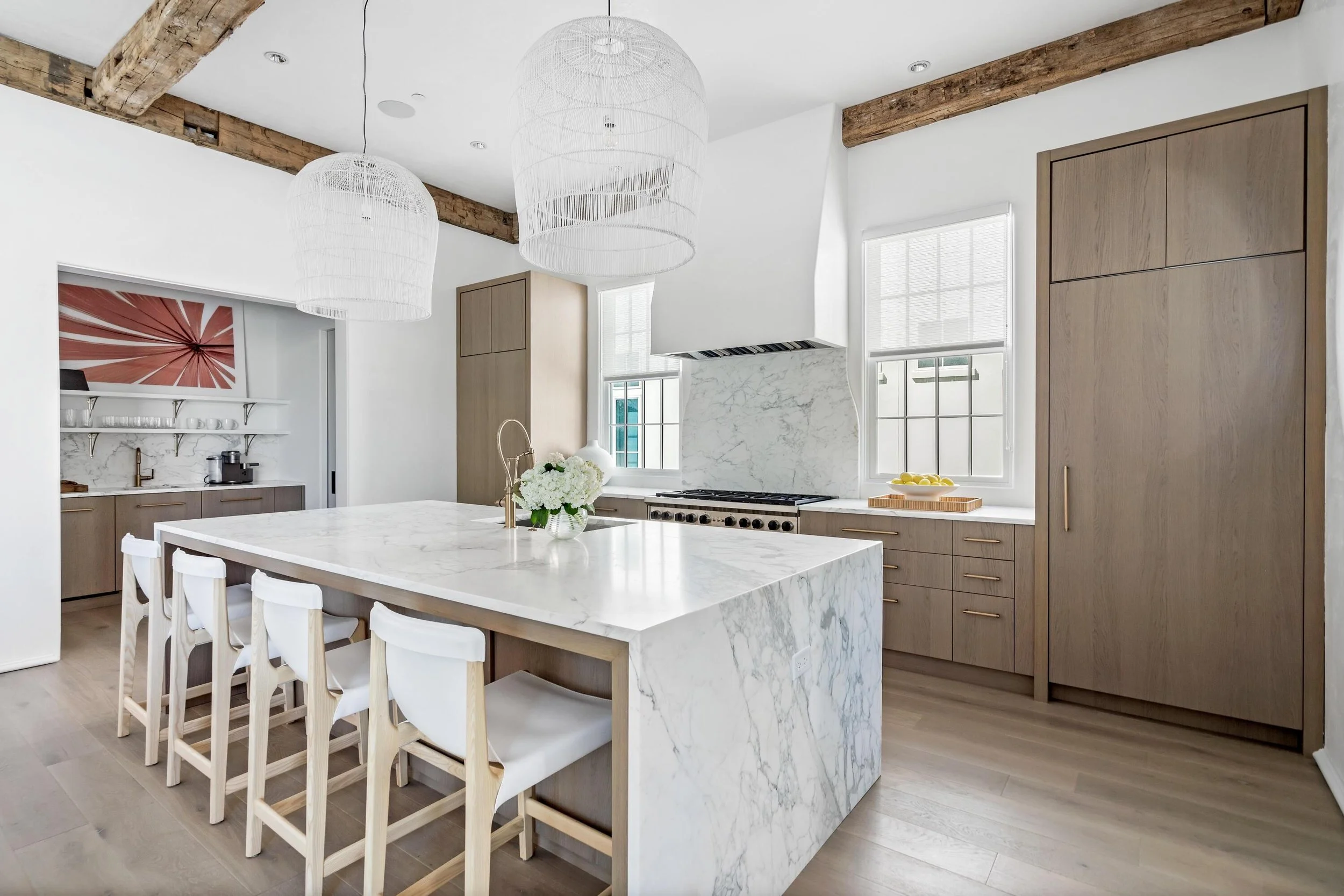 Coastal kitchen with marble island and custom cabinetry