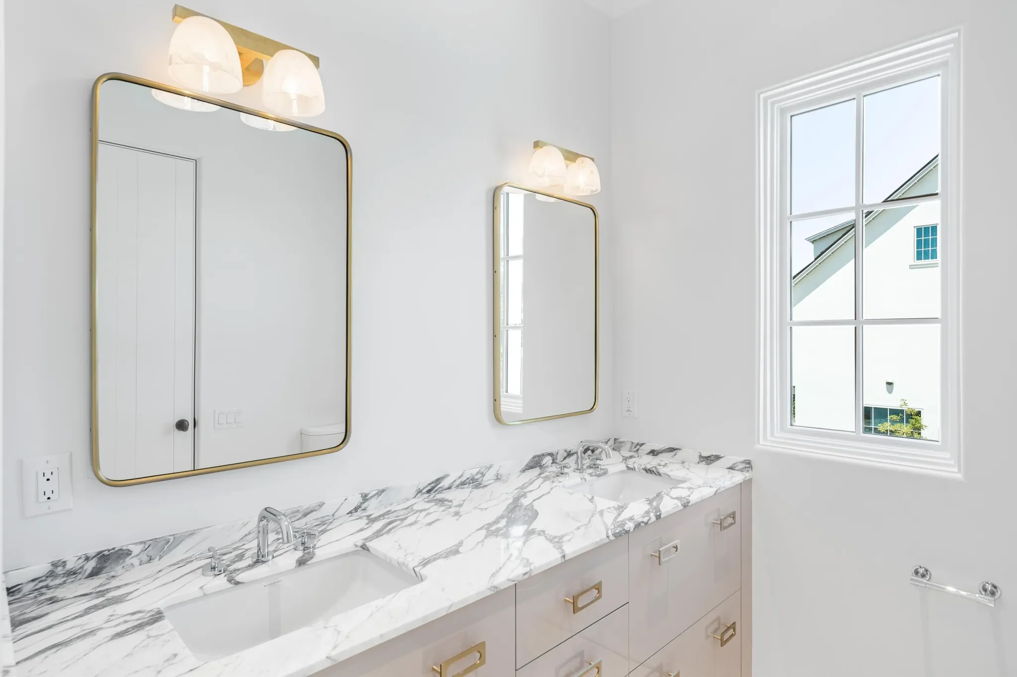 Custom bathroom remodel with marble vanity and brass fixtures