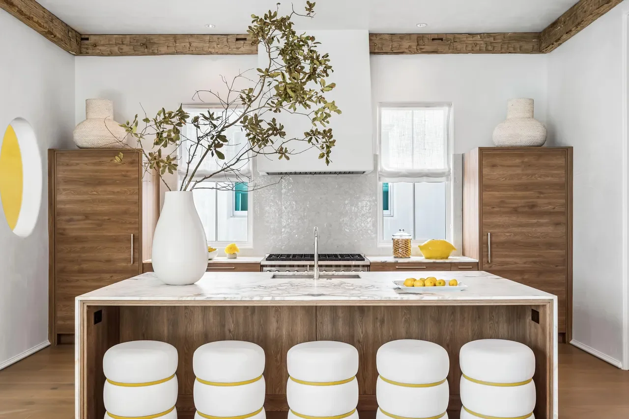 Coastal kitchen with marble island and wood cabinetry