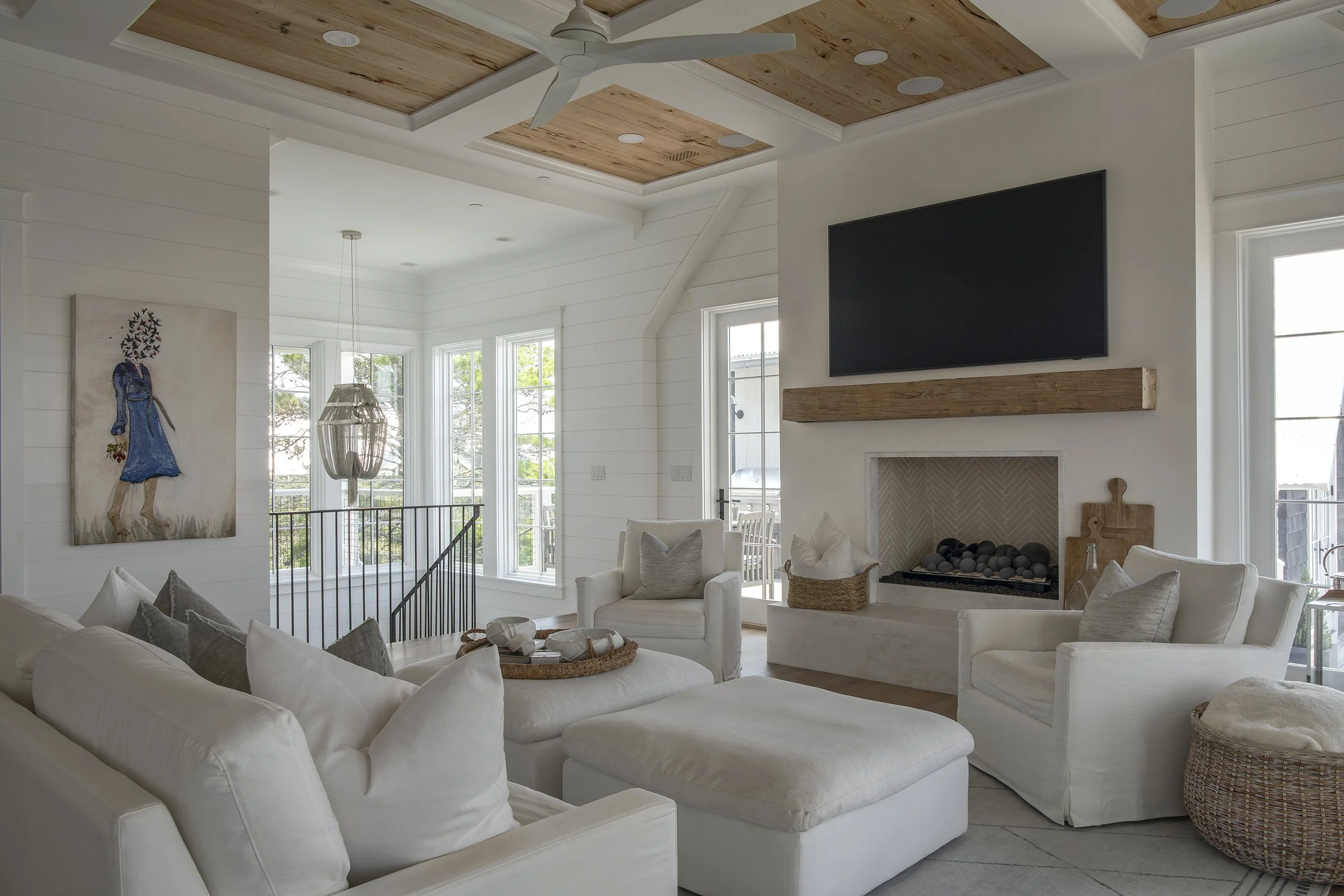 Coastal living space with vaulted ceiling and custom interior details