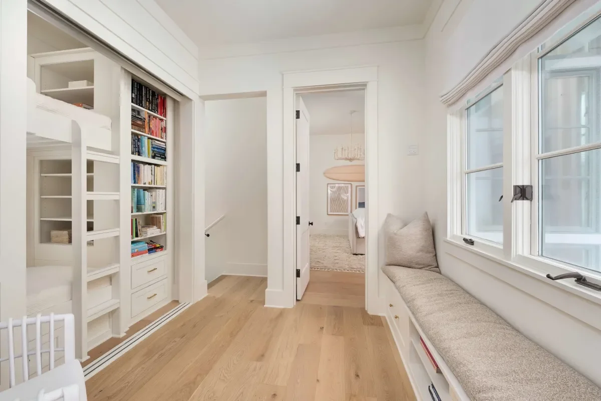 Coastal hallway with built-in shelving and neutral finishes