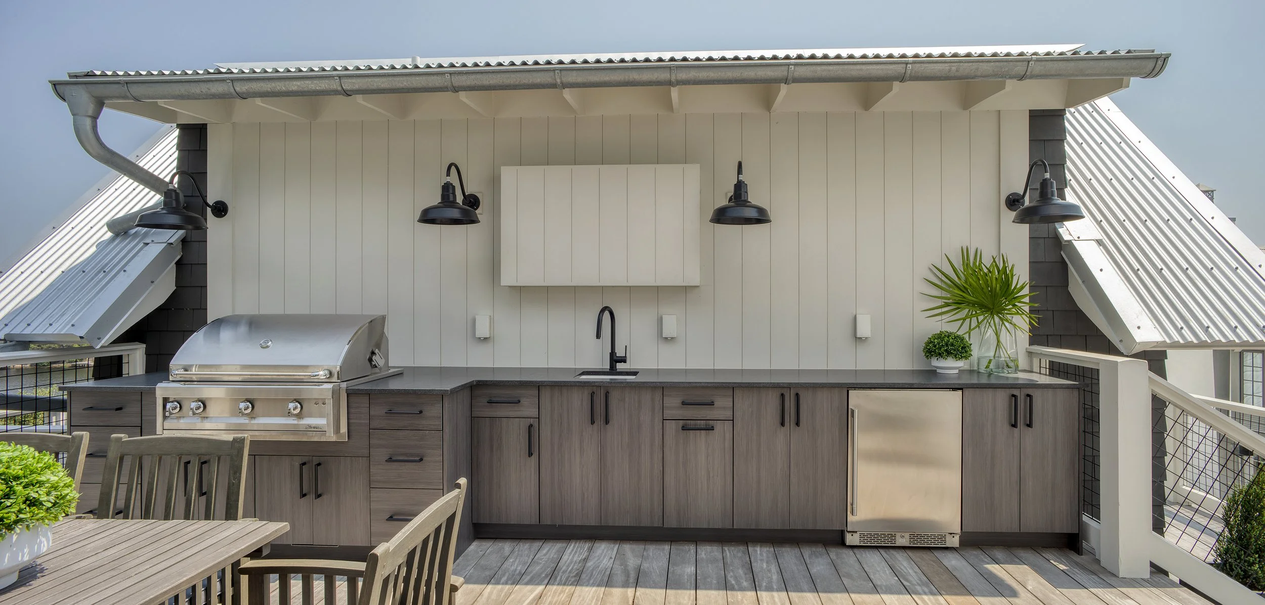 Covered outdoor kitchen designed for second home upkeep
