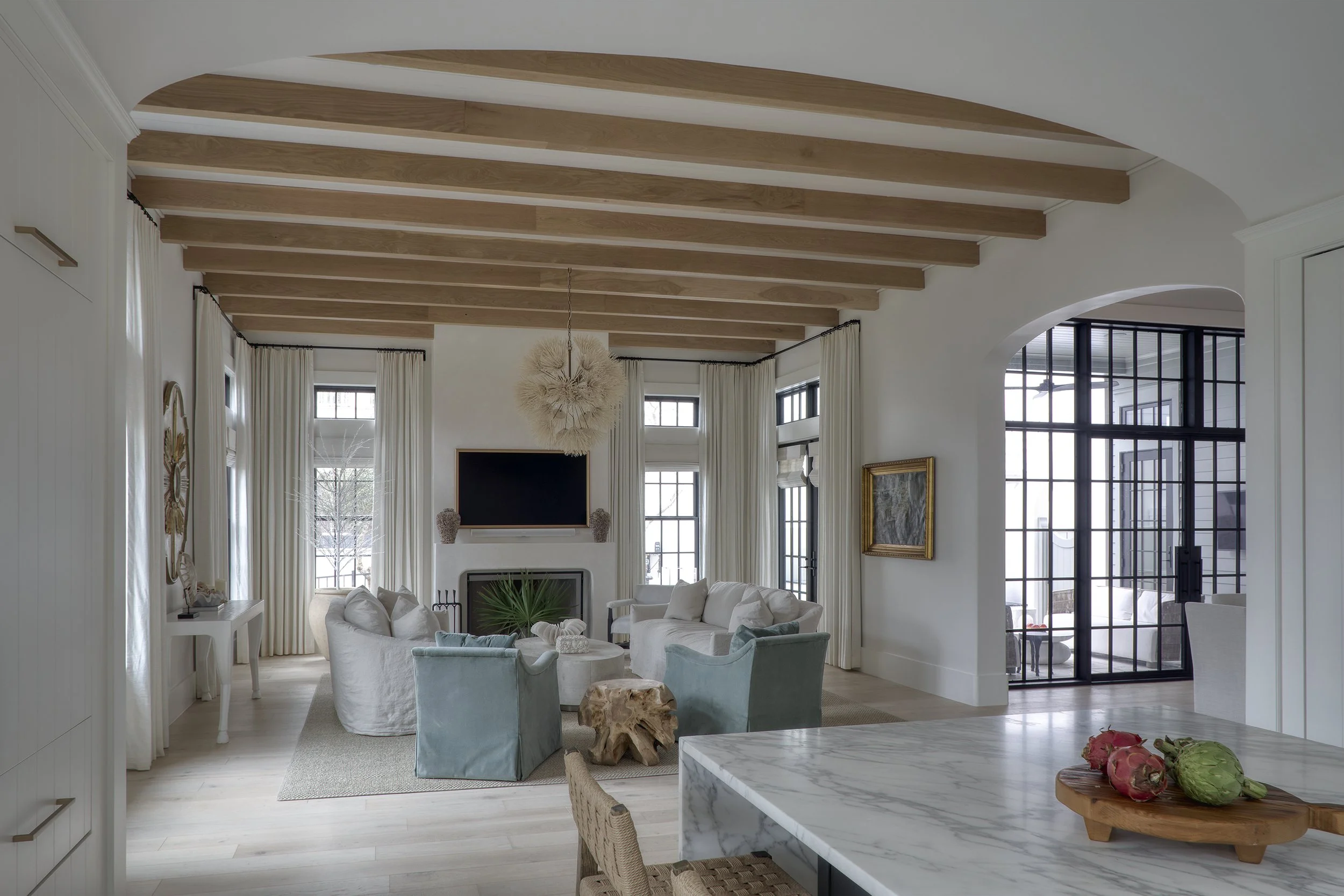 Coastal living room with custom furnishings and natural light
