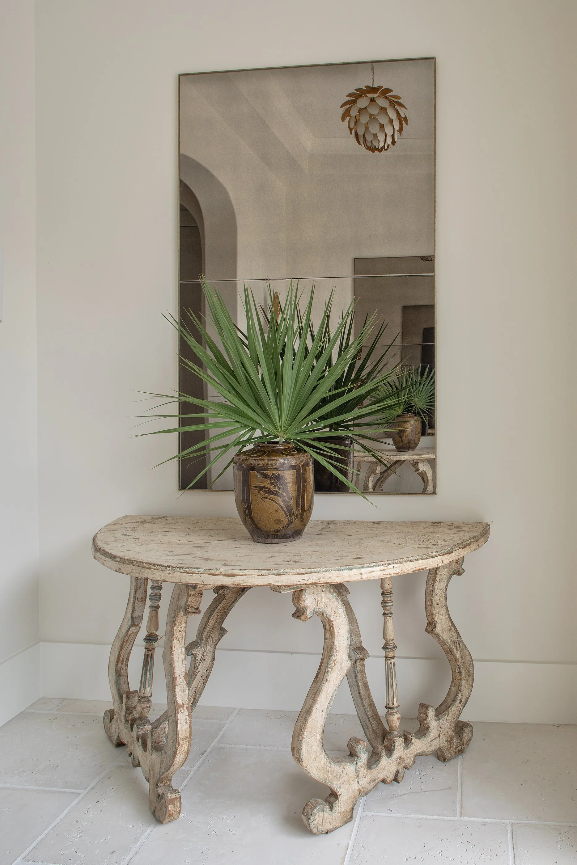 Coastal custom home entryway with arched details and neutral interior finishes