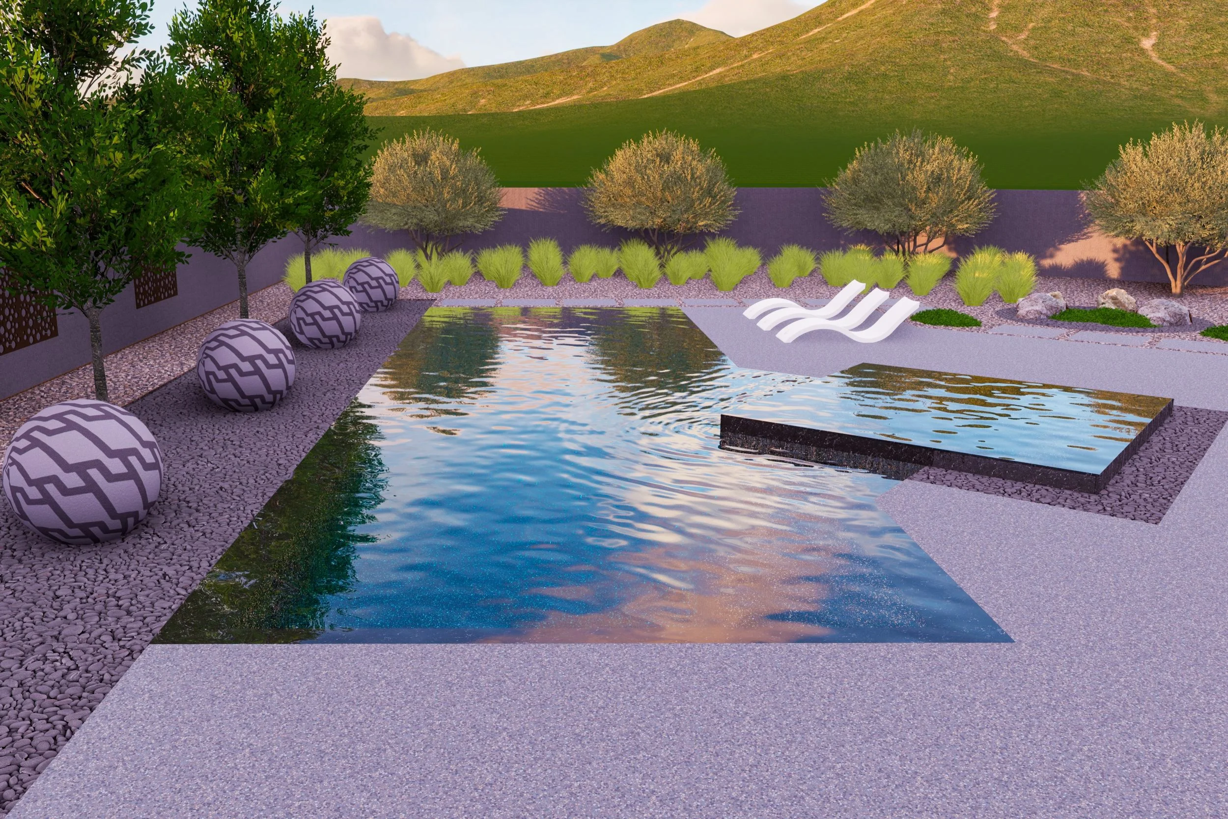 A modern backyard with a rectangular pool surrounded by gravel and paved walkways. There are four white lounge chairs on the right side, decorative spherical objects with a geometric pattern on the left side, and lush trees and bushes along the fence. The background features rolling green hills under a partly cloudy sky.