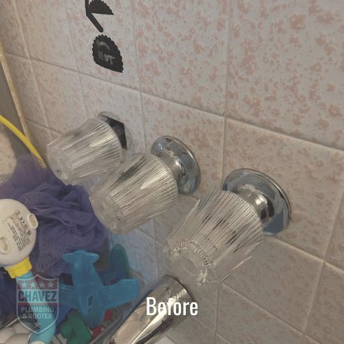 Three glass drinking glasses on a bathroom wall, with a variety of cleaning supplies nearby.