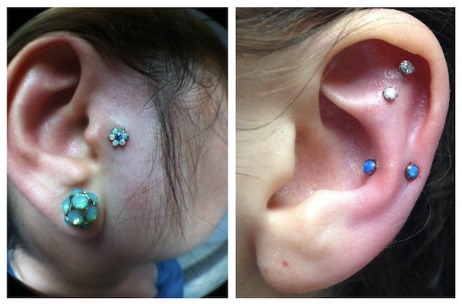 Close-up of multiple earrings on human ears, including a blue flower-shaped earring, turquoise and blue studs, and small clear and blue gems.