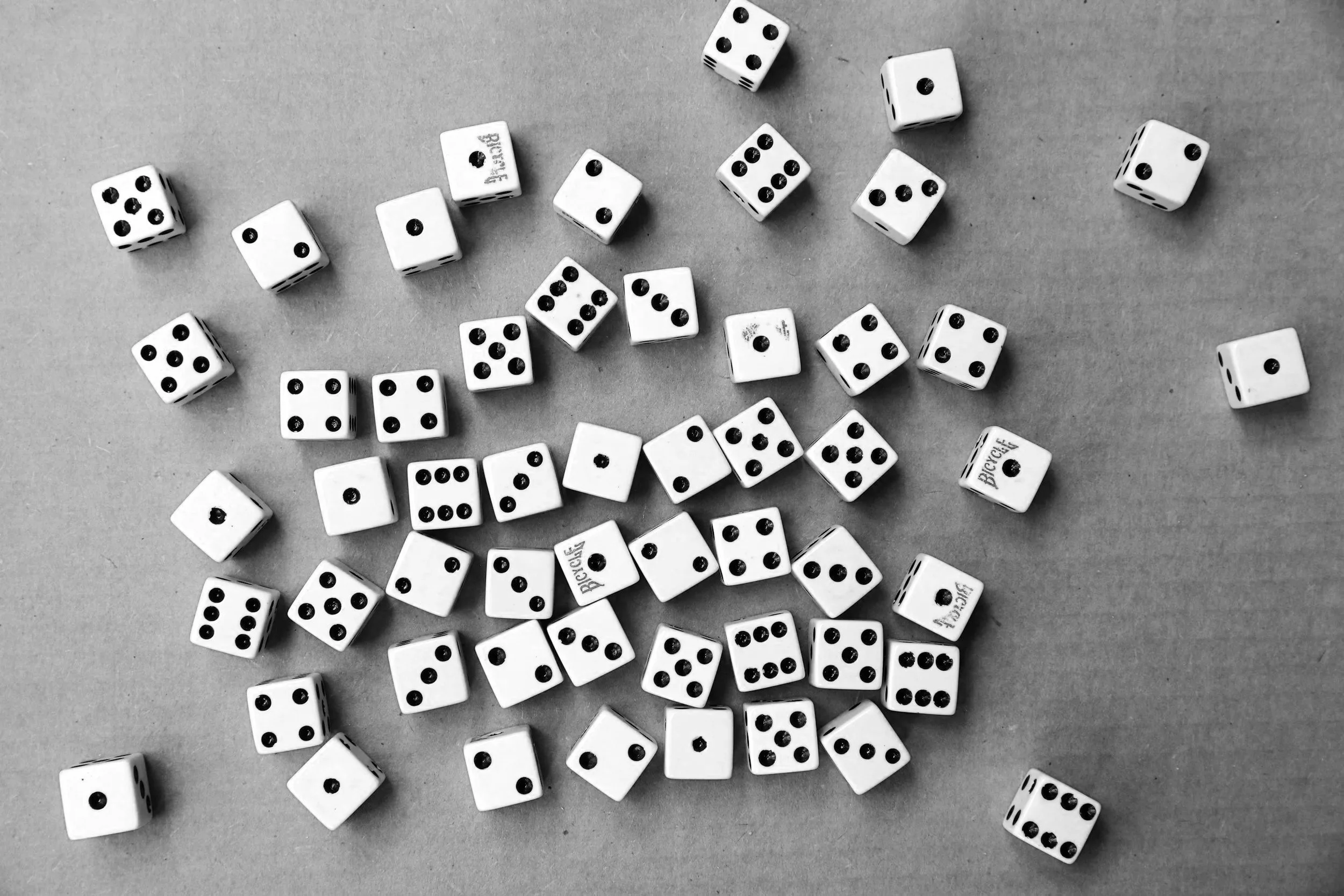 A mountain landscape with snow-capped peaks in the background, grassy hills in the midground, and a modern building on the hillside.