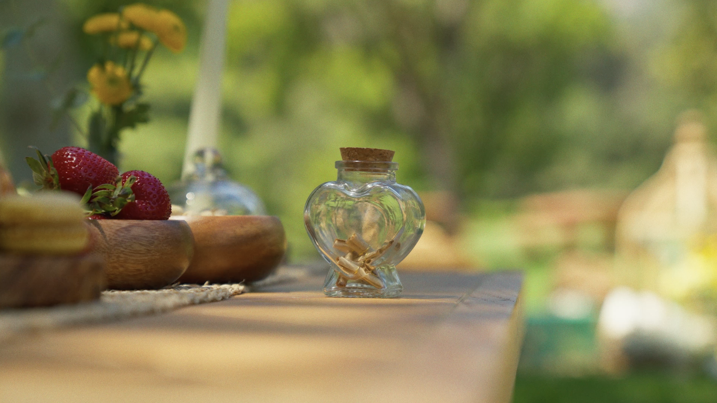 Picnic date decor detail — heart jar, strawberries and florals — Mandra Soul