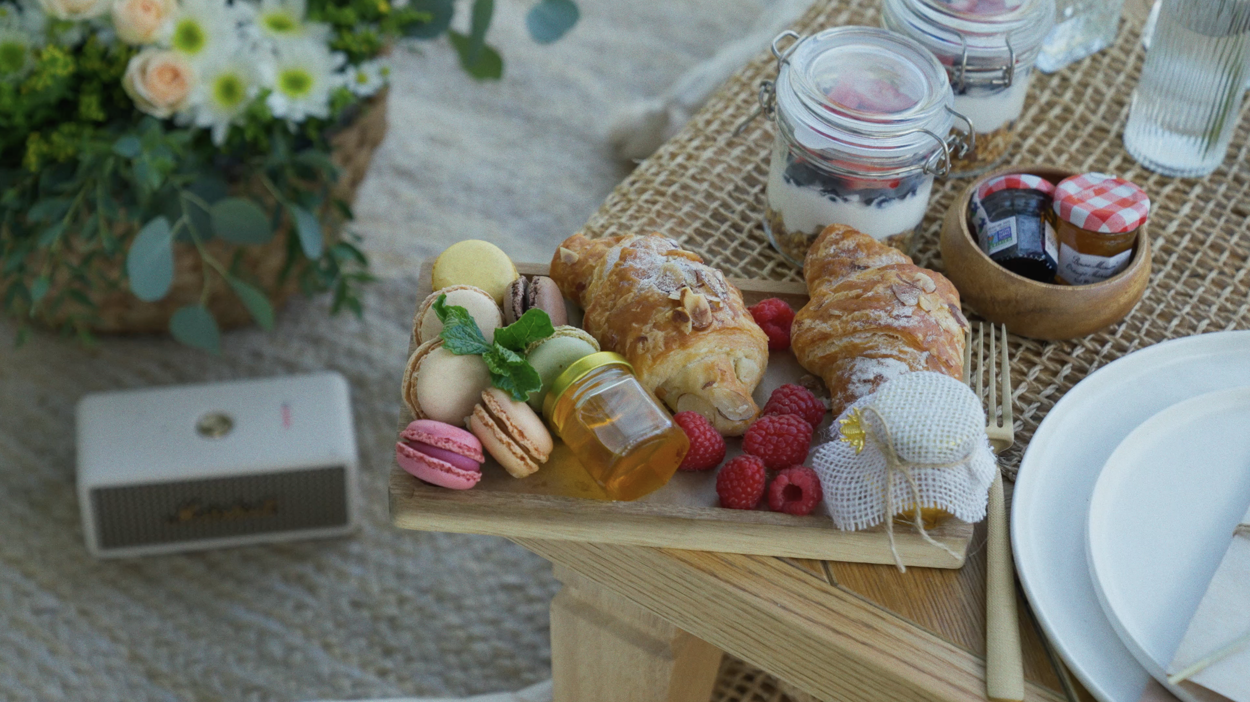 Assortment of colorful macarons and pastries at a picnic date under the trees in Griffith Park — Mandra Soul