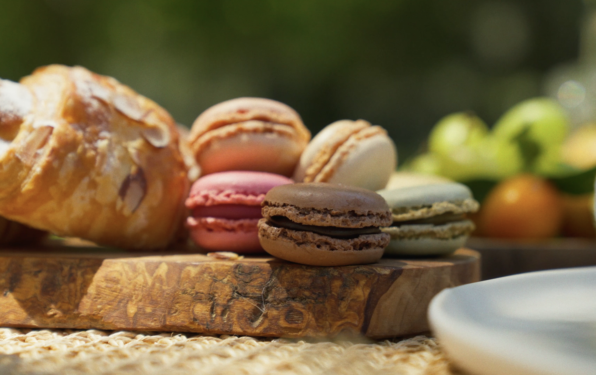 Assortment of colorful macarons and pastries at a picnic date under the trees in Griffith Park — Mandra Soul