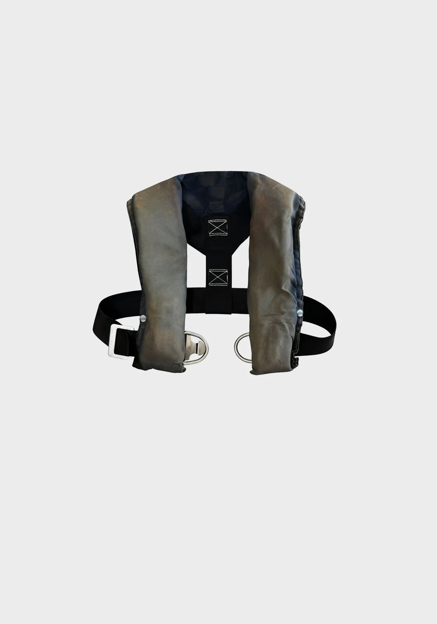 A pair of gray and black life jacket with metal D-rings and adjustable strap.