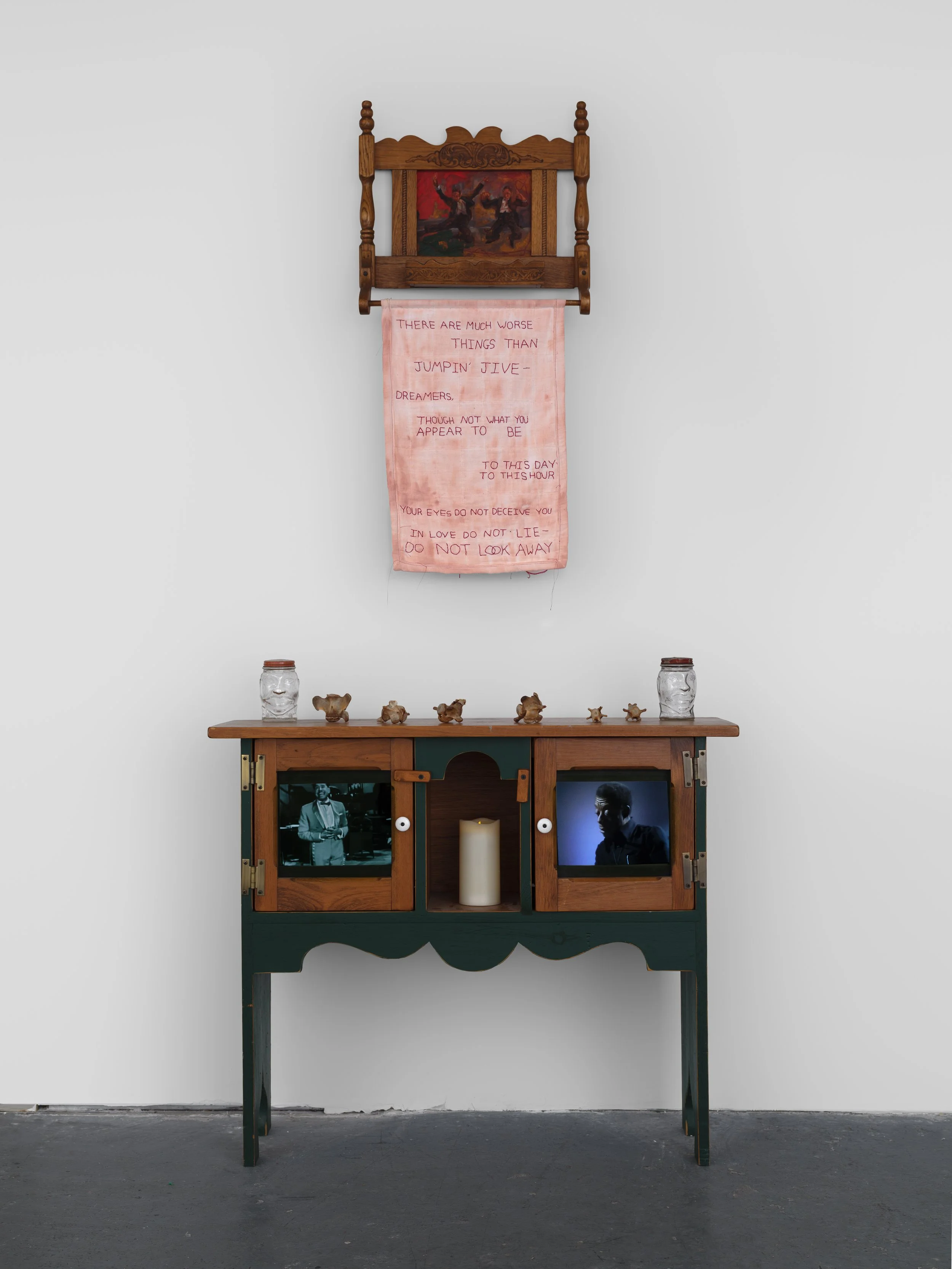 Alexandria Couch | The Teacher : Interstice |  Oil, found antique table, ox tail bones, “Lucky Joe Bank” glass jars, faux candle, video, embroidery on cotton canvas quilt | Dimensions variable | 2026