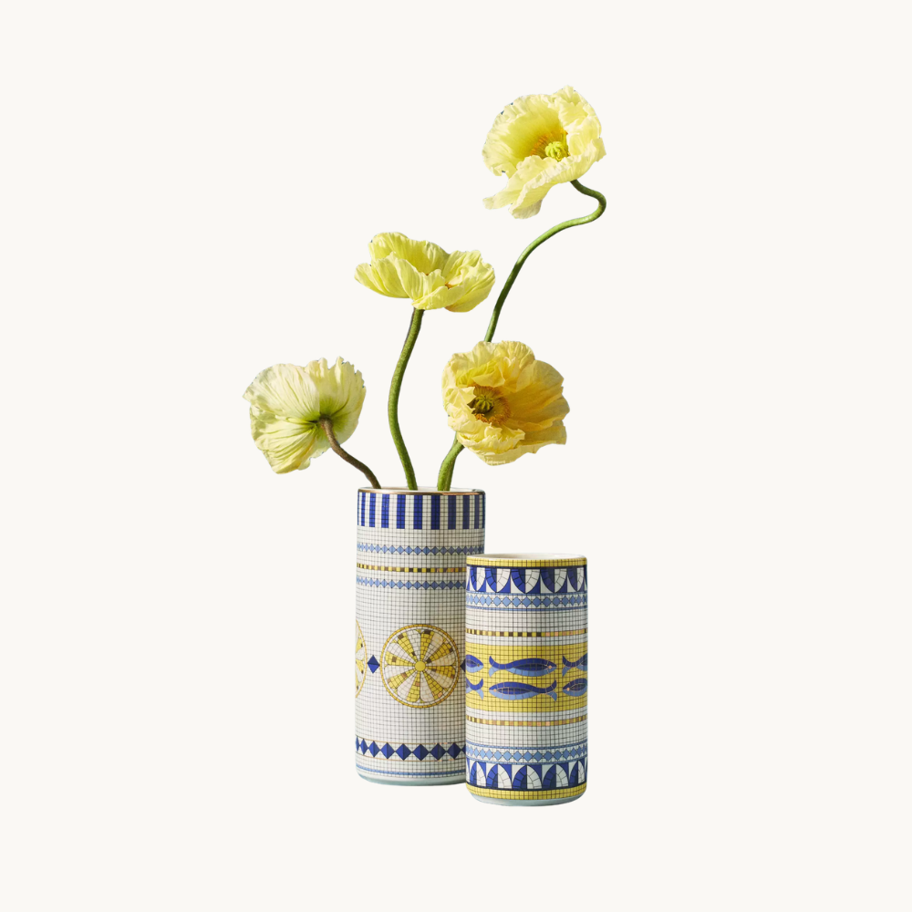 Two decorative vases with yellow flowers against a plain background.