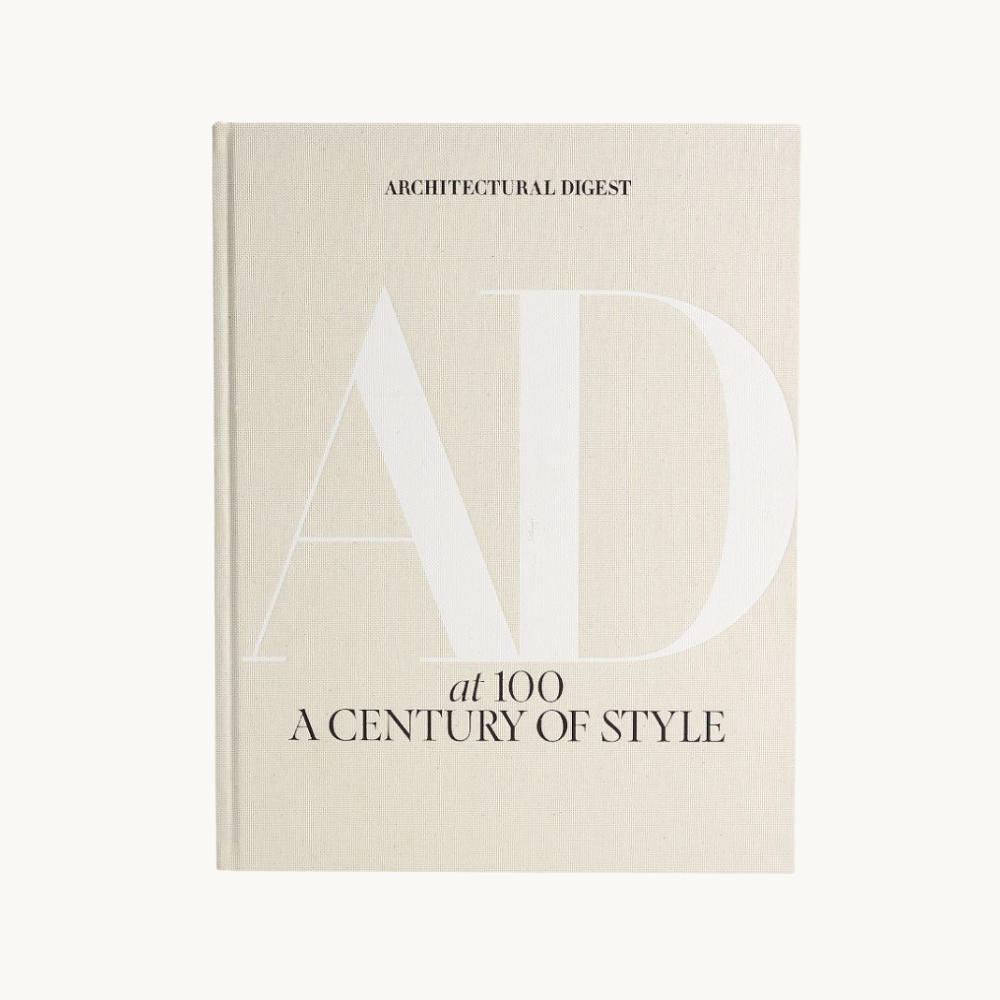 Cover of a book titled 'Architectural Digest at 100: A Century of Style' with a minimalist design and large, light-colored letters 'AD' on a beige background.