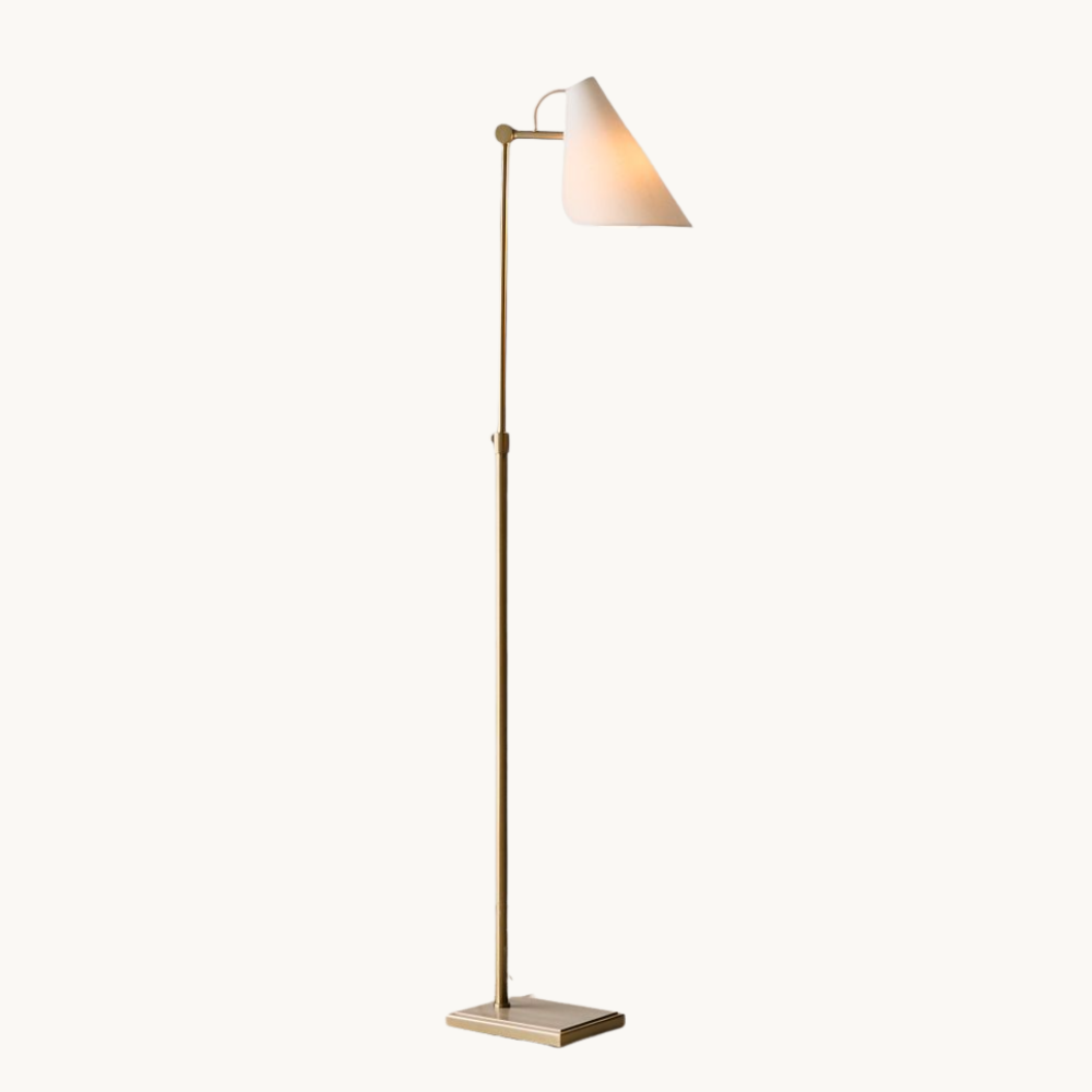 A modern floor lamp with a brass pole, white base, and a white conical lampshade.