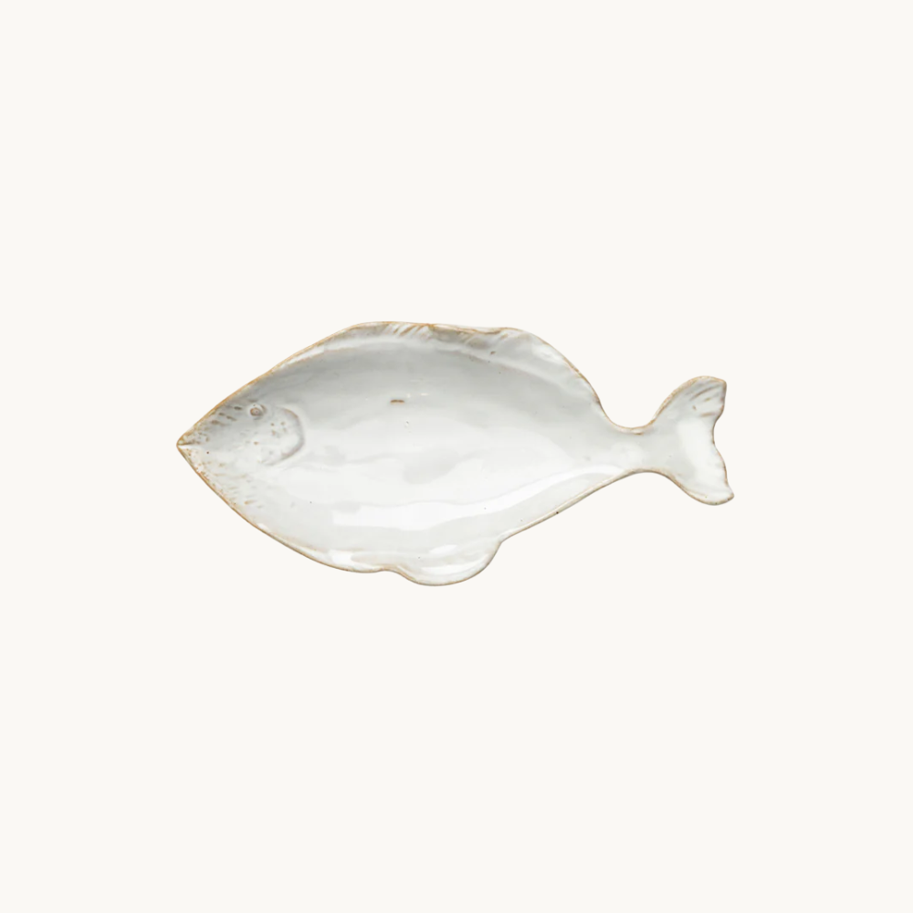 A white ceramic plate shaped like a fish, mounted on a plain white background.