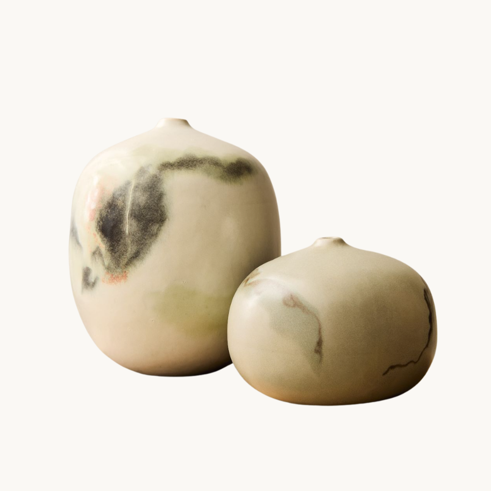 Two ceramic vases with a marbled pattern, one larger and one smaller, placed against a plain white background.