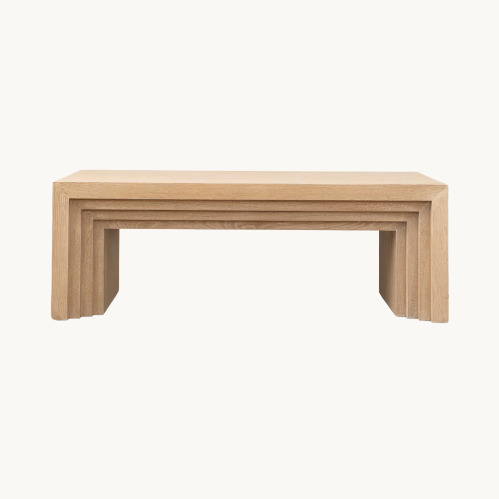 Simple wooden bench with a modern design on a white background.