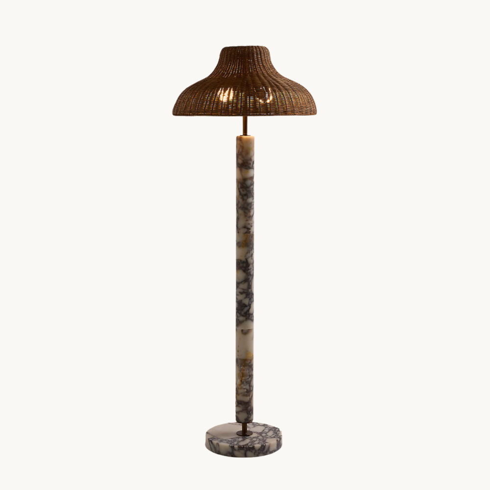 Floor lamp with a marble base and stem, topped with a woven brown shade.