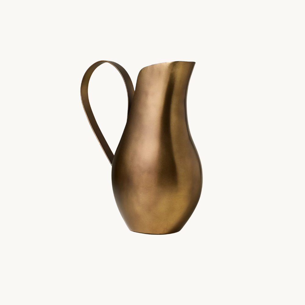 A metallic gold vase with a curved handle and an elongated, narrow opening.