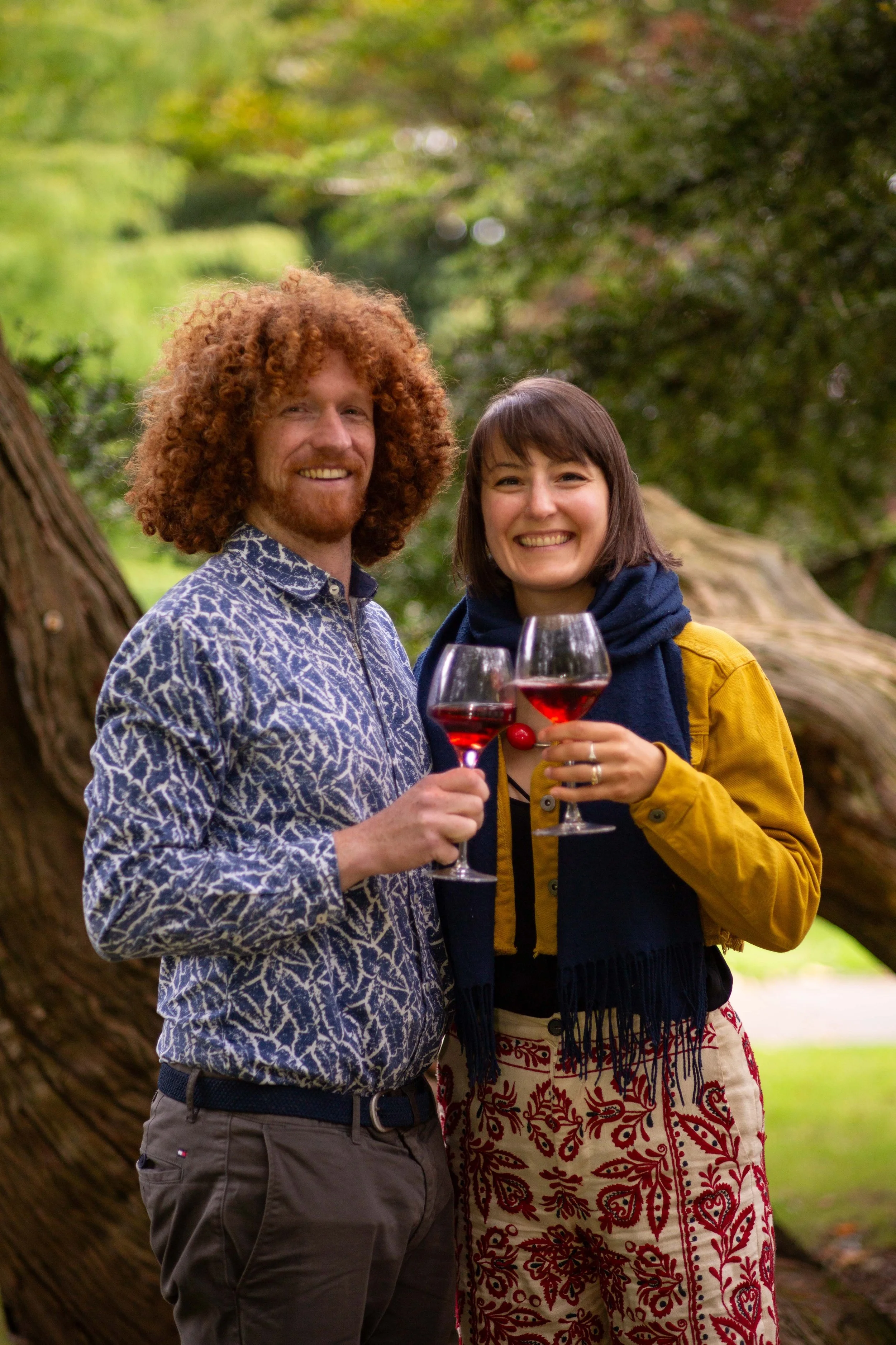 Winemakers Gretchen and Alan pose with a glass of their raspberry wine