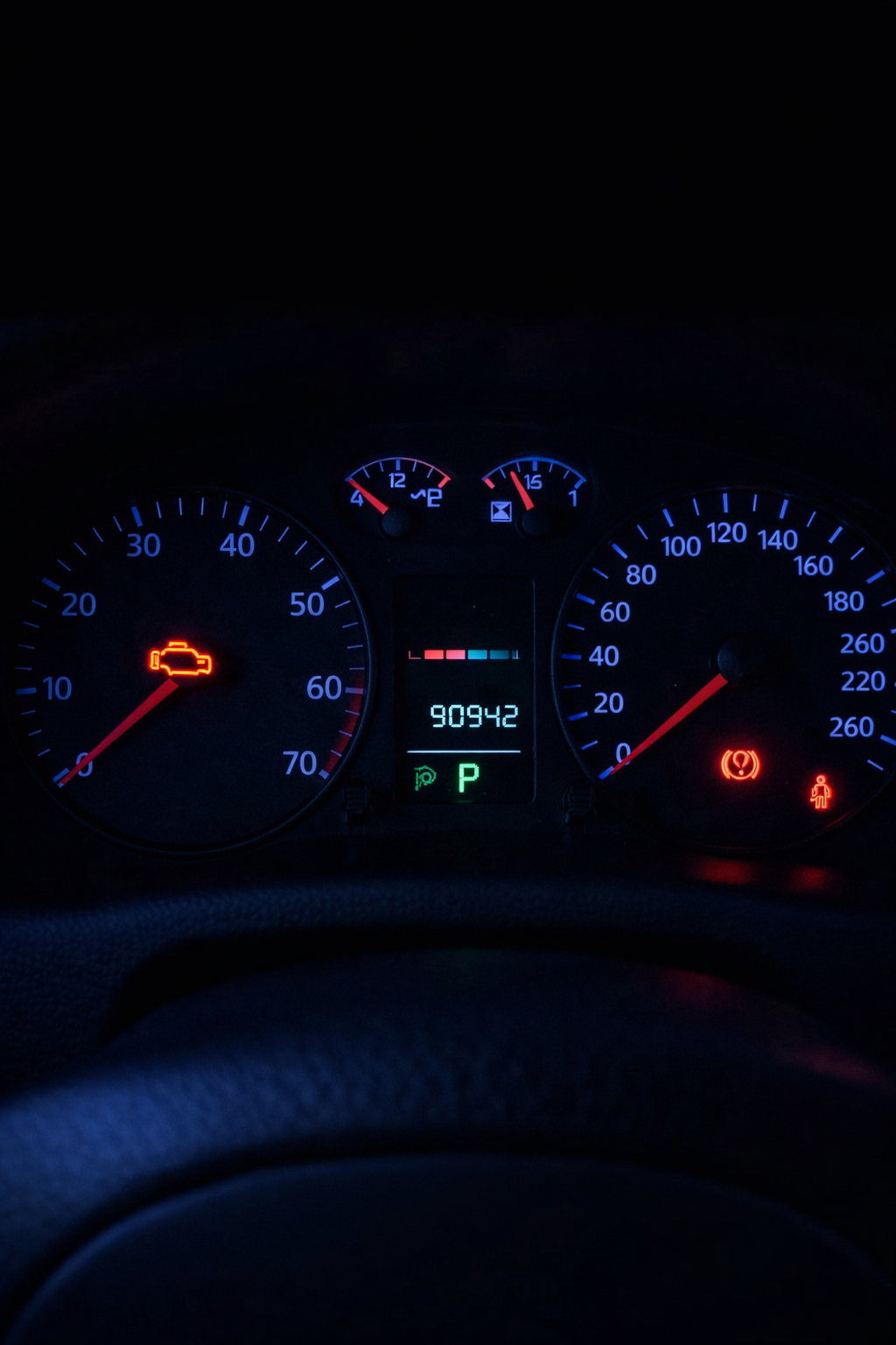 Car dash with check engine light representing how secondary conditions indicate underlying problem.