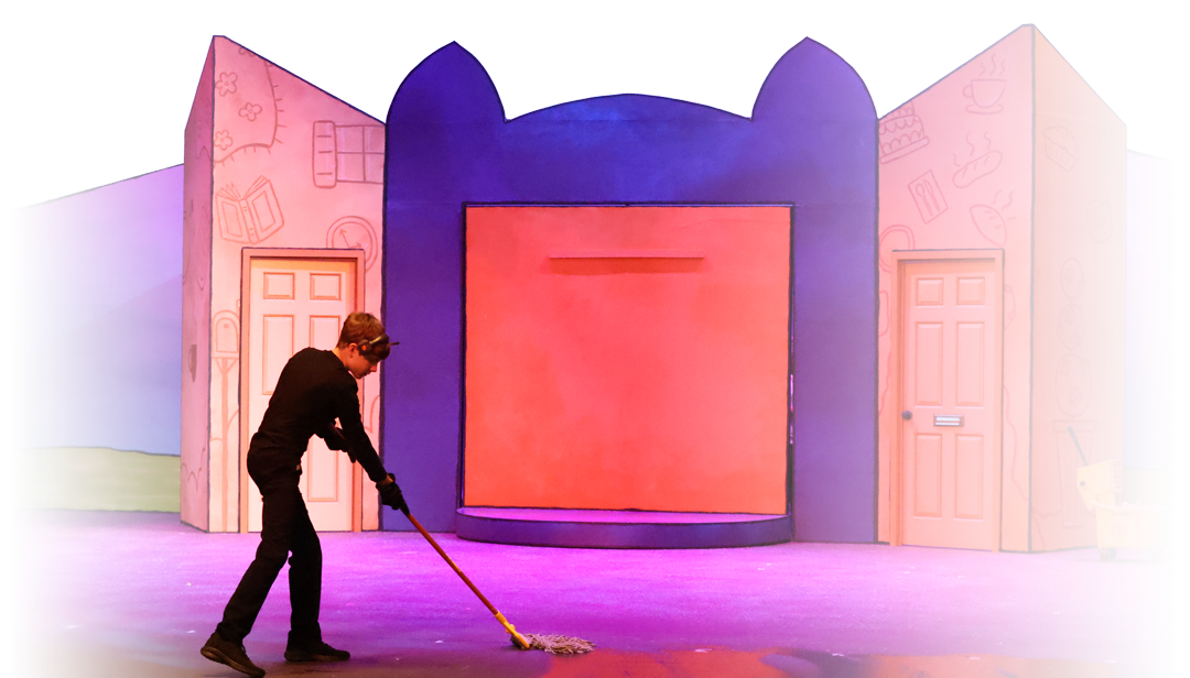 Person mopping stage with colorful cartoon-style background set featuring doors, drawings of household items, and a small shopping cart.