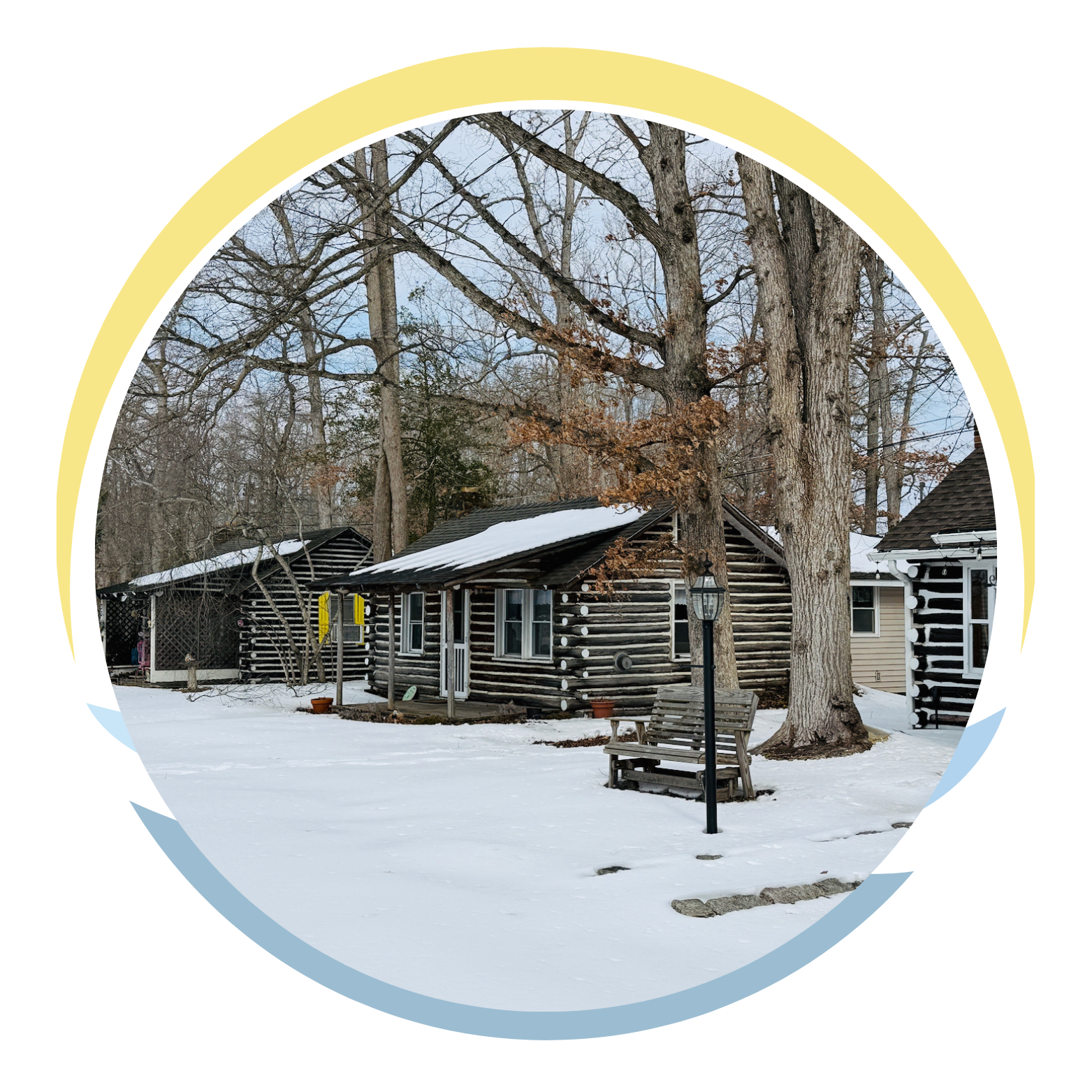 Sand with a large rounded rock and a small pile of green seaweed on top, illuminated by sunlight.