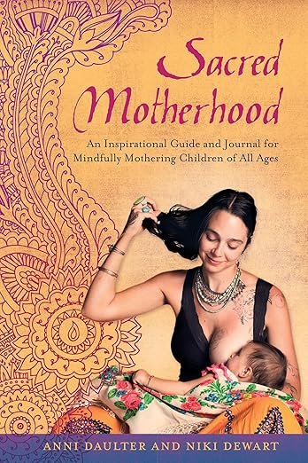Book cover titled 'Sacred Motherhood,' featuring a woman with long dark hair wearing a sleeveless top and layered jewelry, holding a baby wrapped in a colorful blanket, with a decorative background.