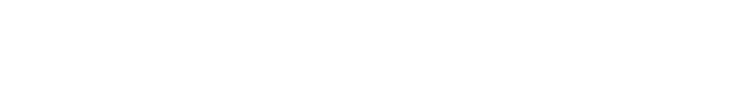 Silhouette of tree tops against a clear sky.