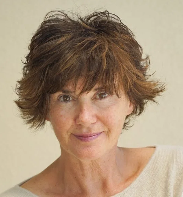 A headshot of Mandy Jackson-Beverly, smiling softly against a plain background.