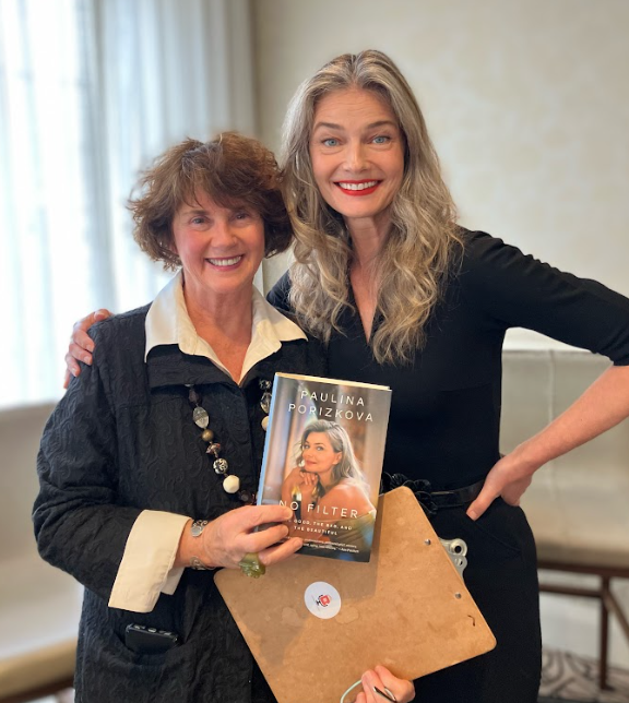 Two women smiling and holding a book titled 'No Filter' by Paulina Porizkova.