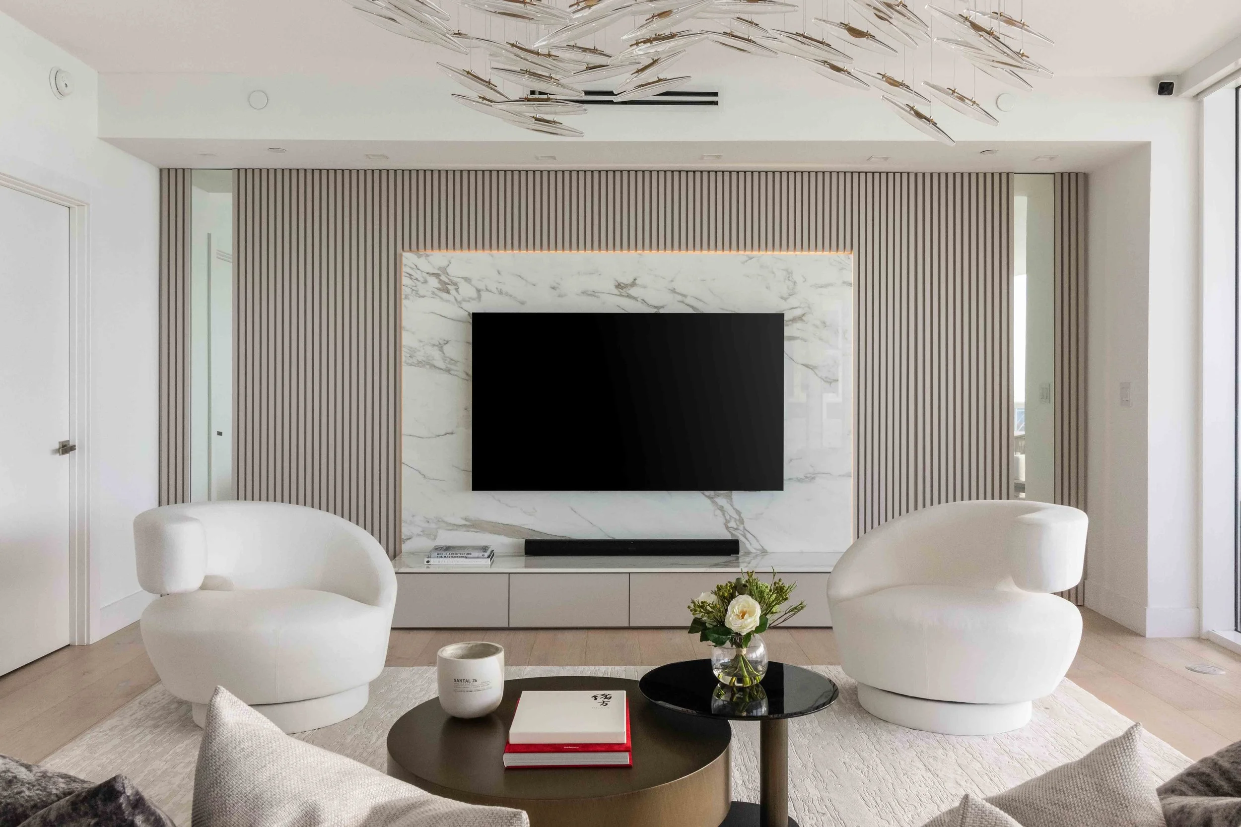 Modern living room with hidden doorway - Murano Grande - South of Fifth Design - CURATED. Studio