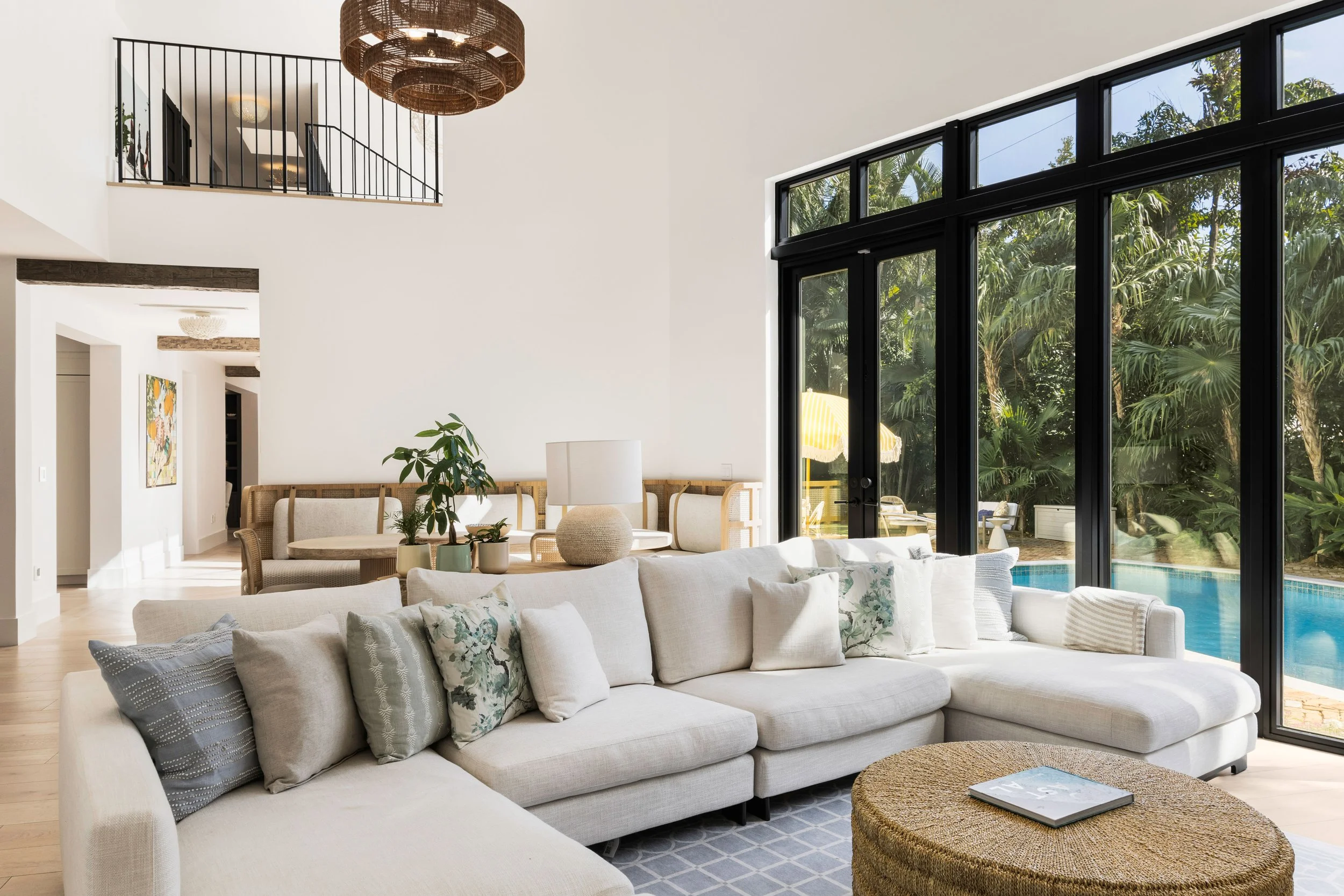 Modern family room overlooking a garden/pool space - Coastal Boho Estate - Coconut Grove - CURATED. Studio